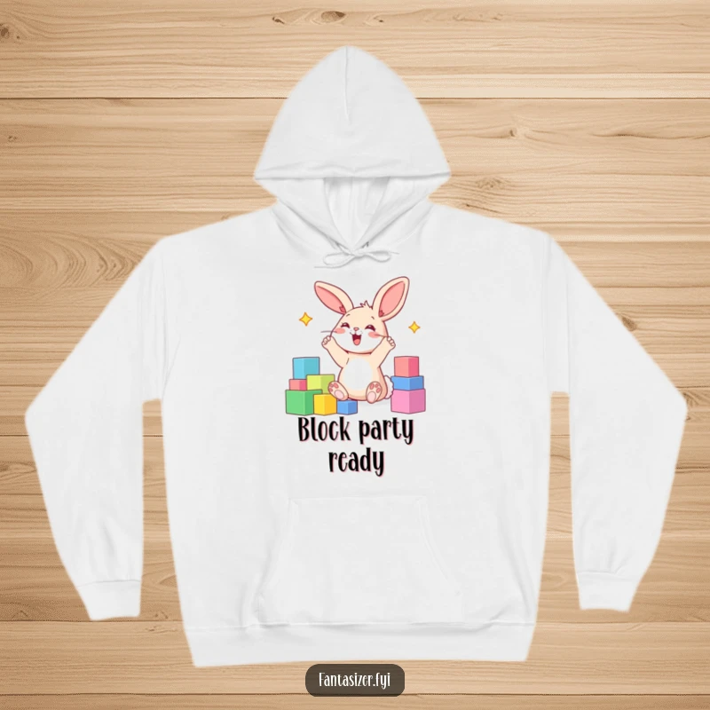 Funny hoodie design of a happy bunny with paws in the air, imagining a world made of colorful blocks.